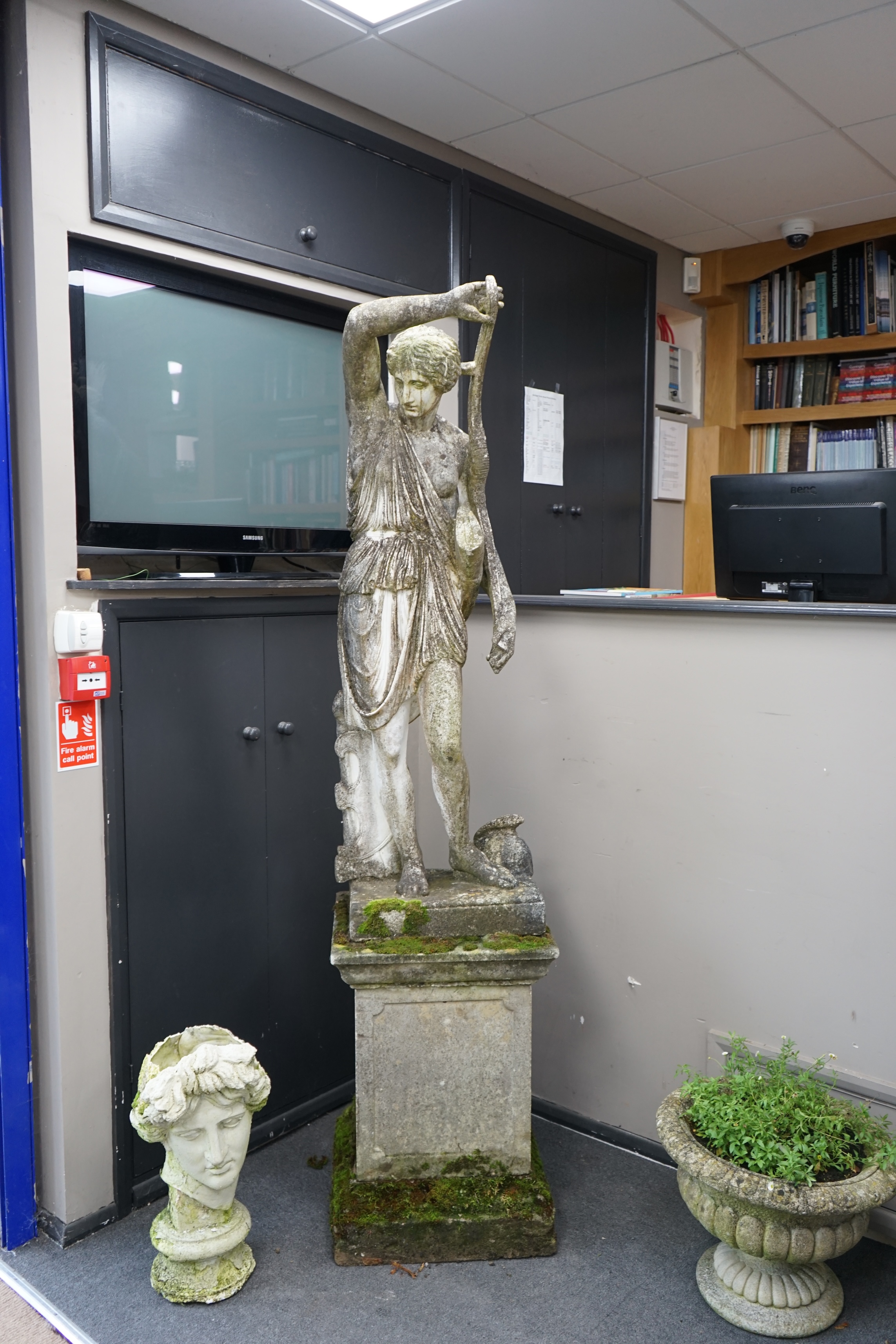 An Italian composition marble statue of Diana the Huntress, on a square reconstituted stone plinth